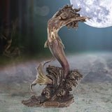 Mermaid statue with 'Yemaya' inscription against a moonlit sky