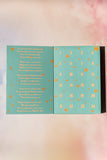 Teal advent calendar with gold numbers and text on a blurred background