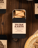 Tribe Earth handmade incense packaging on a wooden surface