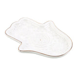 White ceramic dish shaped like a hand on a white background