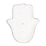 Hamsa-shaped dish on a white background