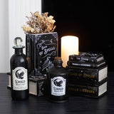 Decorative setup with black bottles labeled 'Dried Crow's Feet' and 'Book of Spells' on a dark surface.